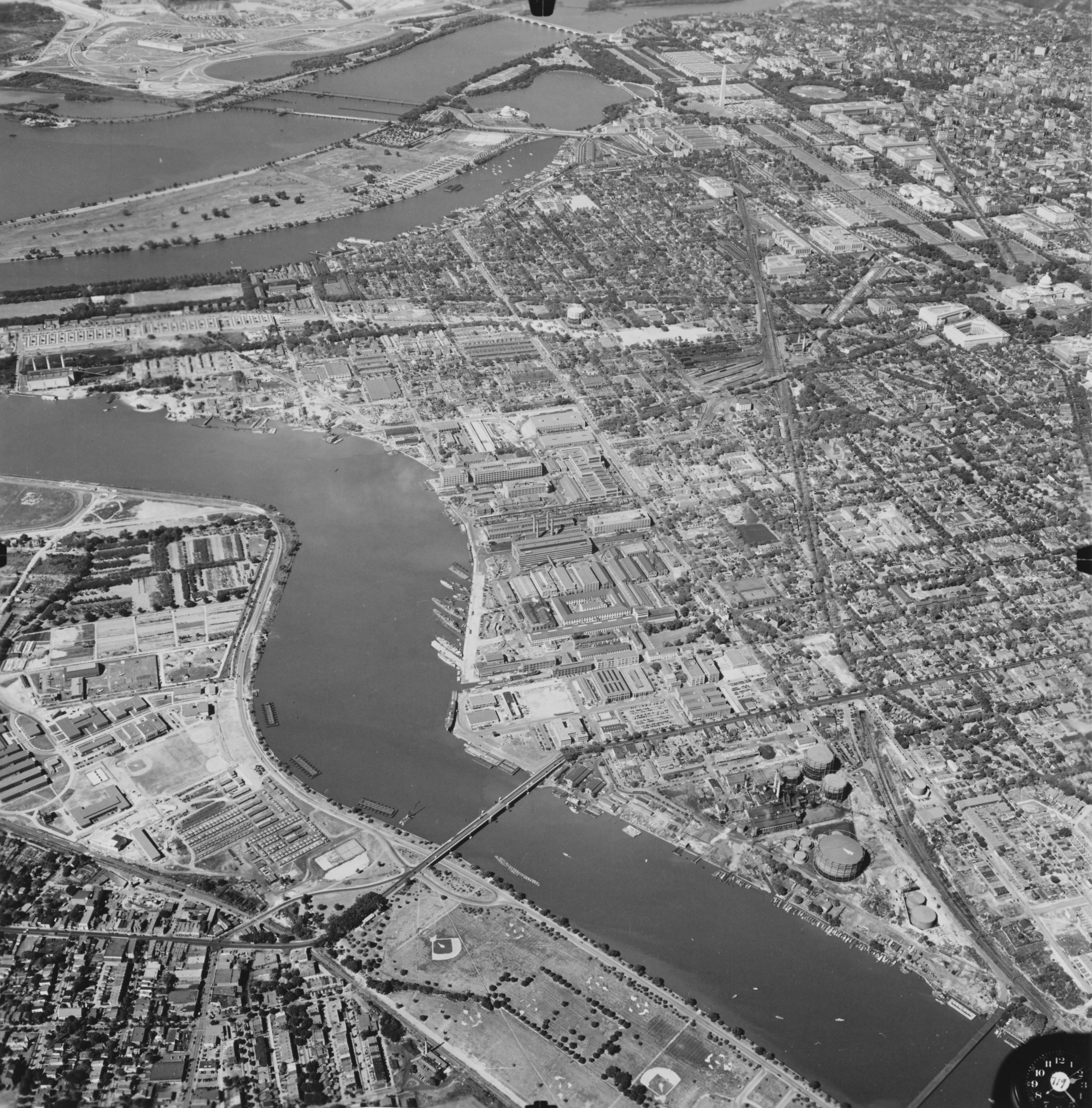 Aerial view of the Anacostia River winding through Washington, DC in 1944, the Washington Navy Yard and Boathouse Row lining its banks.